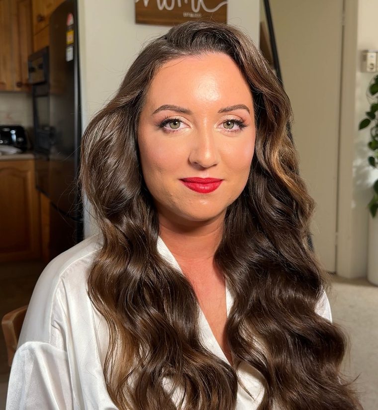 A race-day look: a red lip and long glossy waves